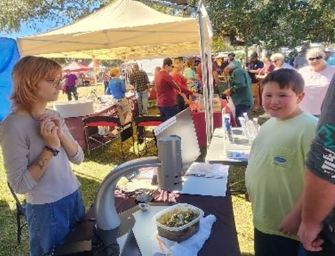 Research Intern, Emily Mosely (L) talking about oysters with visitors.